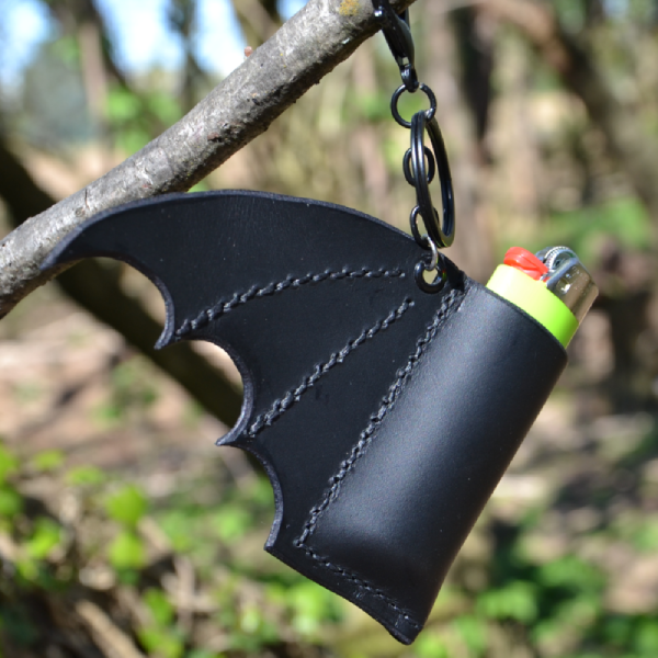 Bat wing keychain that holds your lighter or lipstick.